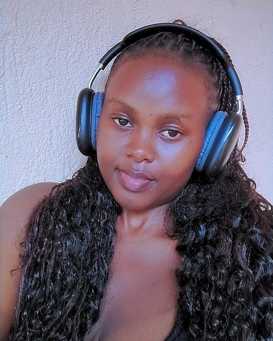 Portrait of Jadline Njeri wearing headphones